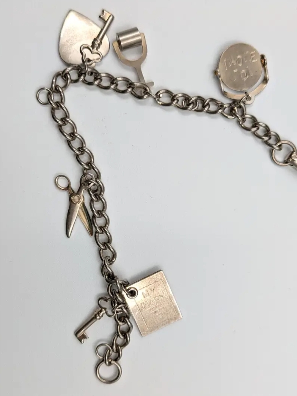 Silver Charm Bracelet with ILU Spinner, Scissors, Key & Heart Charms
